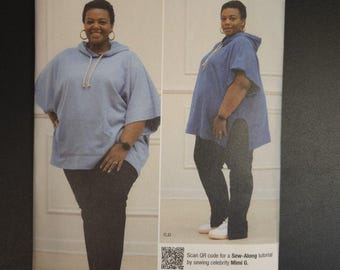 May include: Simplicity sewing pattern S9637 featuring a woman wearing a light blue hooded top and black pants. The pattern includes sizes 20W-28W. The brand is "mig" and the pattern is "easy-to-sew".