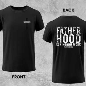 May include: Black t-shirt with a white cross and the text "Proverbs 22:6" on the front. The back of the shirt features the words "FATHERHOOD IS KINGDOM WORK" with "Proverbs 22:6" below. A lion's face is on the left.