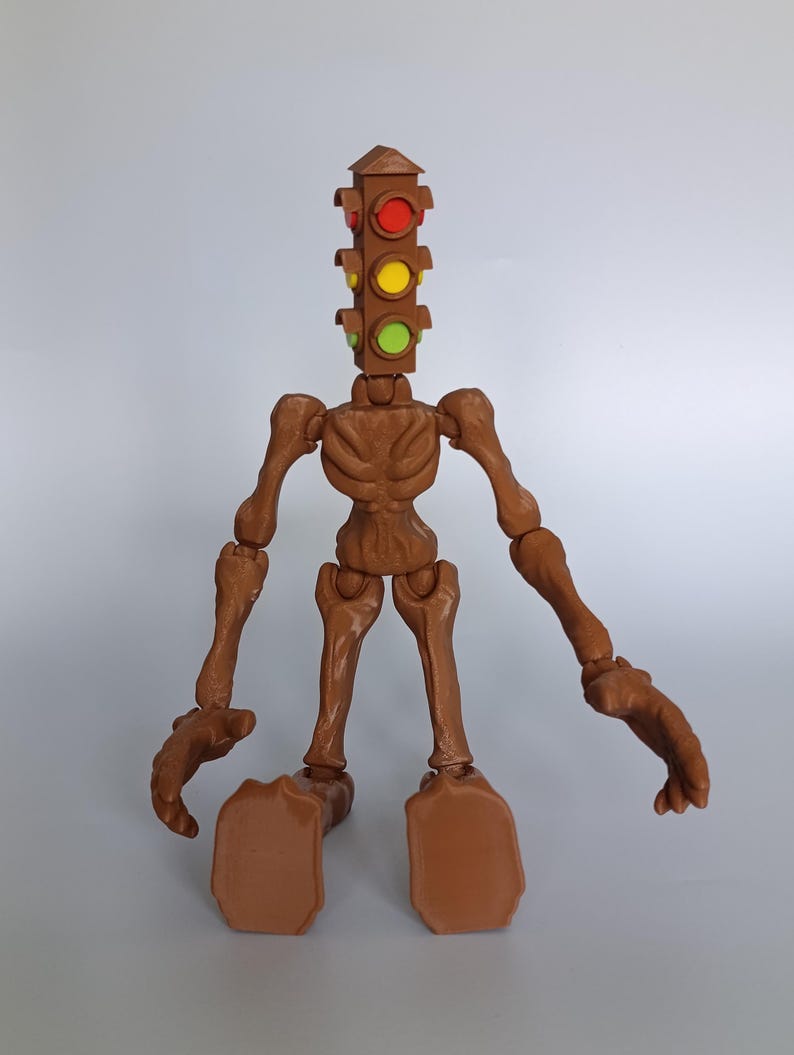 May include: A brown articulated figure with a traffic light head. The figure has a skeletal appearance with visible joints and a torso. The traffic light head features red, yellow, and green lights. The figure is posed on a plain background.