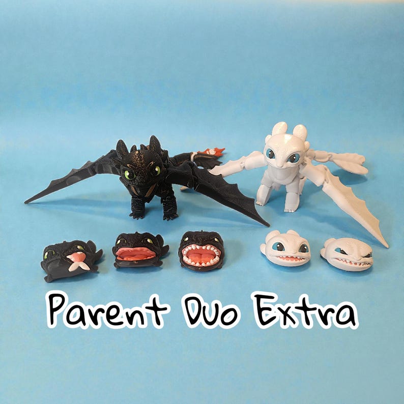 May include: A collection of dragon figurines, including a black dragon with outstretched wings and a white dragon. Several smaller dragon heads with different expressions are also displayed. The text "Parent Duo Extra" is visible.