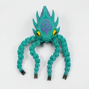 May include: A teal articulated creature toy with a stylized design. The toy has a head with purple accents and yellow eyes, and multiple segmented tentacles. The tips of the tentacles are black. The toy is on a white background.