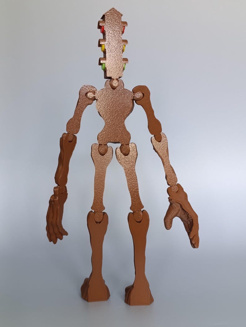 May include: A brown wooden articulated figure with a textured finish. The figure has a segmented design with movable joints, including arms, legs, and a head with colorful accents. The figure stands upright.