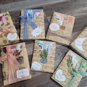 May include: Seven wrapped gifts on a wooden surface. The gifts are wrapped in patterned paper, tied with ribbons, and adorned with decorative elements like stickers and dried flowers. The color palette includes beige, pink, blue, and green.