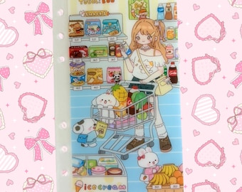 May include: Clear plastic binder cover with a colorful illustration of a girl shopping in a grocery store. The illustration includes cartoon animals, snacks, and the text "Total: 300" and "SNACKS". The background is a pink pattern with bows and hearts.