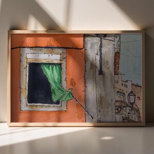 May include: A framed watercolor painting depicting an orange building facade with a dark window and a green curtain blowing outward. The scene includes a gray wall section, a street lamp, and architectural details rendered in ink and watercolor.