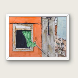 May include: A watercolor painting in a white frame depicting an orange building facade with a dark window and a green curtain blowing outward. A gray wall section, a black street lamp, and distant building outlines are visible in the background.