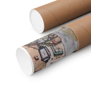 May include: A rolled-up art print featuring a detailed ink and watercolor illustration of a street scene with architectural elements, displayed partially inside a brown cardboard mailing tube with white circular end caps.