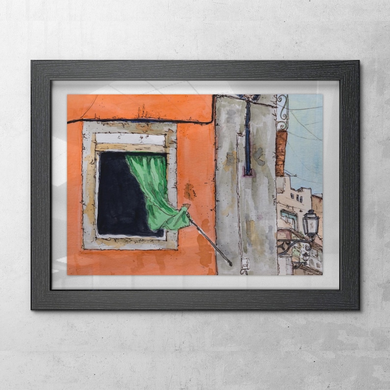 May include: A framed watercolor painting depicting an orange building facade with a dark window opening. A green curtain hangs from the window, and a black metal street lamp is attached to the adjacent gray wall. The artwork features ink outlines.