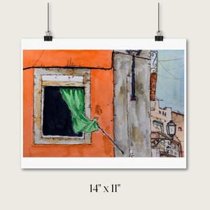 May include: A watercolor painting measuring 14 inches by 11 inches depicting an orange building facade with a window featuring a green curtain. A gray wall section, a black street lamp, and distant building outlines are visible in the scene.