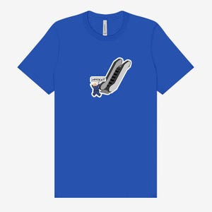 May include: Royal blue t-shirt featuring a cartoon graphic of an escalator with a person waving and the word "UPPIES!!!" in a speech bubble. The graphic is in shades of gray, black, and blue.