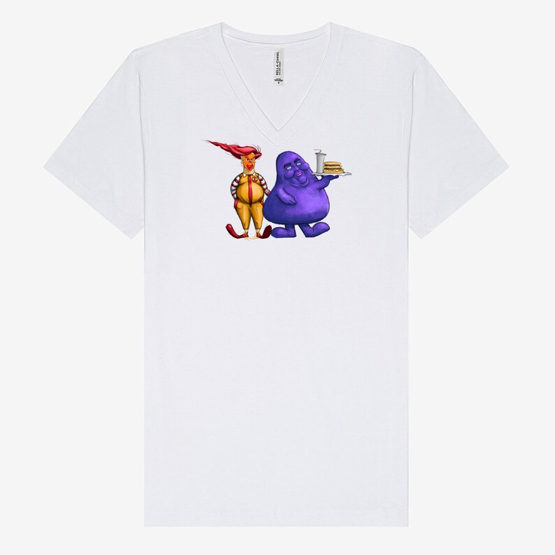 May include: White V-neck t-shirt featuring a cartoon illustration of two characters. One character is purple and holding a tray of food, and the other is yellow and red. The shirt is made of a soft material.