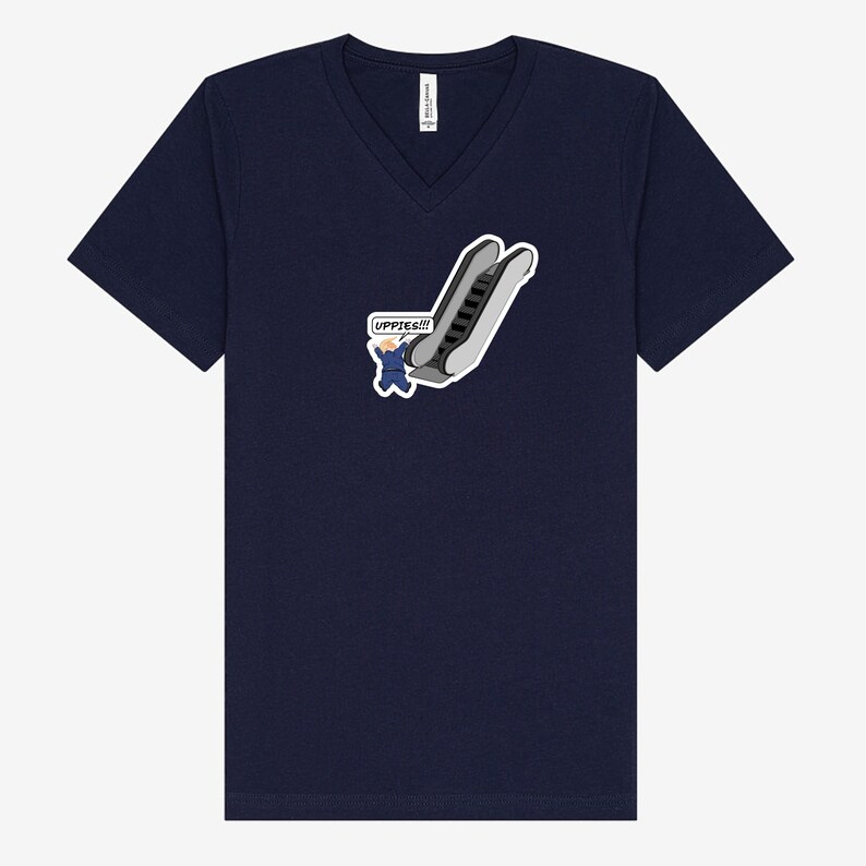 May include: Navy blue V-neck t-shirt featuring a cartoon graphic of an escalator with a person waving and the text "UPPIES!!!" in a speech bubble. The graphic is in shades of gray, white, and blue.