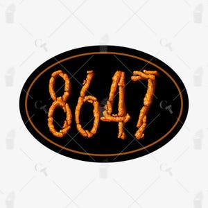 May include: An oval-shaped sign with the number "8647" in a fiery orange font against a black background. The sign has a thin, brown border and is likely a decorative item.