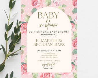 May include: A baby shower invitation with a floral design. The invitation features the text "BABY in bloom" and details for Elizabeth & Beckham Bass's baby shower, including the date, time, and location. The invitation is registered at Amazon.