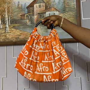 Afro Script Orange Ankara Bag – Bold Afrocentric Handbag with Wooden Handles, African Print Tote for Everyday Style