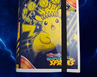 May include: A trading card binder featuring a yellow Pikachu character with a spiky crown, surrounded by floating gold coins against a dark blue background. The cover displays the text Scarlet & Violet Surging Sparks and includes a black elastic strap.