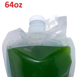 May include: A clear plastic pouch containing a vibrant green liquid, with a white cap and handle. The text "64oz" is printed in red at the top. The pouch is filled with a liquid that appears to be a health supplement or beverage.