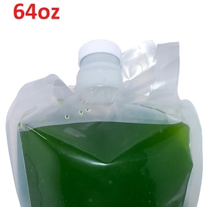 May include: A clear plastic pouch containing a vibrant green liquid, with a white cap and handle. The text "64oz" is printed in red at the top. The pouch is filled with a liquid, possibly a beverage or a cosmetic product.