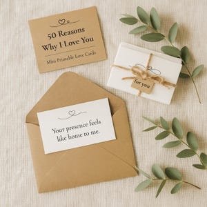 May include: A collection of love-themed stationery. Includes a brown envelope with a card that reads "Your presence feels like home to me." A small stack of cards tied with twine and a tag that says "for you." A card that says "50 Reasons Why I Love You."