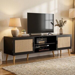 May include: A long black media console featuring two side cabinets with light-colored woven cane panels and a central open shelf. The unit is supported by four light-colored wooden tapered legs and holds a flat-screen television and a speaker.