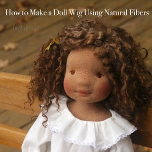May include: A doll with curly brown hair wearing a white shirt with a ruffled collar and a yellow ribbon in her hair. The doll is sitting on a wooden bench. The text "How to Make a Doll Wig Using Natural Fibers" is at the top of the image. The text "petit gosset" is below the title.