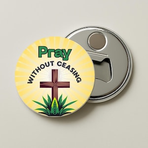 May include: A round bottle opener with a religious theme. The opener features a yellow background with the words "Pray Without Ceasing" and a brown cross. The opener is silver with a bottle opener on the side.