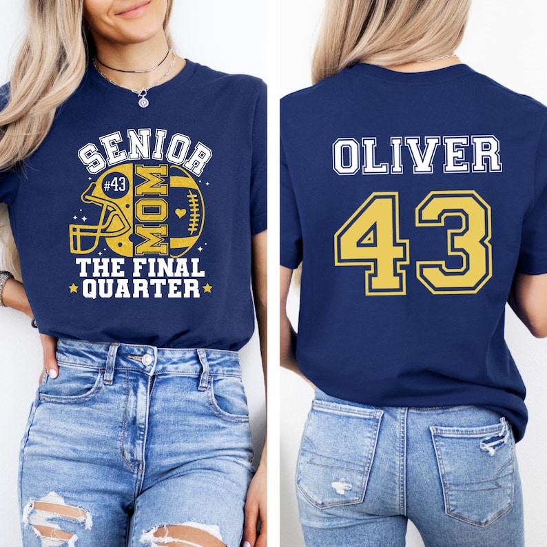 May include: A navy blue t-shirt featuring a front graphic with a yellow football helmet, the text SENIOR MOM THE FINAL QUARTER, and #43. The back of the shirt displays the name OLIVER in white and the number 43 in yellow with a white outline.