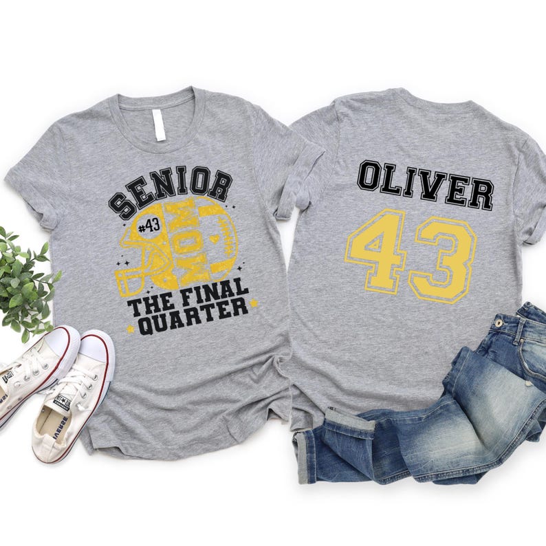 May include: Two heather gray t-shirts. The left shirt features a yellow football helmet graphic with the text SENIOR MOM THE FINAL QUARTER and #43. The right shirt displays the name OLIVER in black and the large yellow number 43.