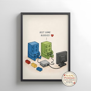 May include: A framed wall art print featuring a blue and a green block-shaped character playing a video game together. The text BEST GAME BUDDIES! with a red heart is above them. Small yellow, red, and blue blocks are on the floor nearby.
