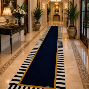 May include: A long rectangular runner rug featuring a solid navy blue centre, a thin mustard yellow border, and a wide outer edge with alternating black and white vertical stripes. The rug is positioned on a polished light-coloured tile floor.