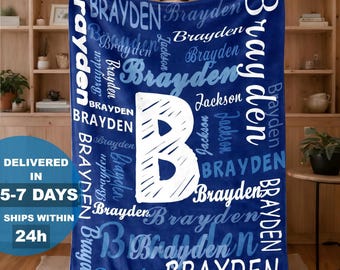 May include: A dark blue fleece blanket featuring a large white letter B in the center, surrounded by the repeated names Brayden and Jackson in various white and light blue fonts, styles, and sizes across the entire surface of the fabric.