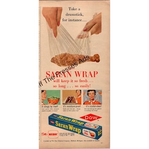 May include: Vintage advertisement for Saran Wrap. The image shows a drumstick wrapped in clear plastic wrap, with text promoting the product's freshness and clarity. A box of Saran Wrap is also displayed.