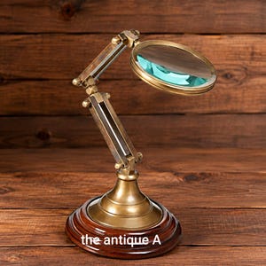 May include: A brass magnifying glass on an adjustable articulated arm with a circular lens and a dark wood base. The base features the text the antique A. The metal components have a weathered finish, and the lens reflects a light blue hue.