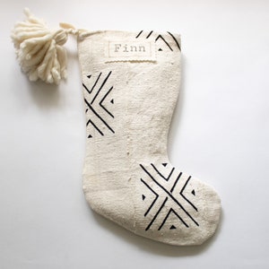 These stockings are creamy white with black tribal patterns and each one is truly unique. These handcrafted African textiles are full of texture with a soft hand. Add an optional nametag and/or wooly pom pom for a special touch.