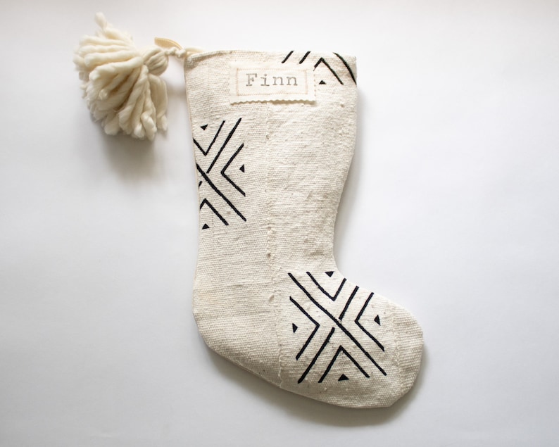 These stockings are creamy white with black tribal patterns and each one is truly unique. These handcrafted African textiles are full of texture with a soft hand. Add an optional nametag and/or wooly pom pom for a special touch.