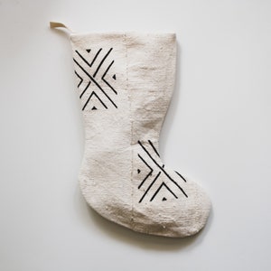 Stocking is cream with a large stylized black X pattern