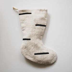 Stocking is cream with staggered chunky black dashes