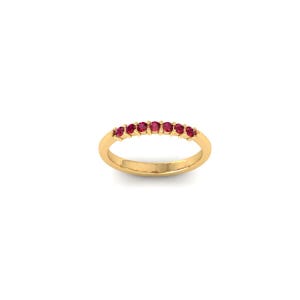 May include: A gold ring with seven small, round, red gemstones set in a row. The ring has a polished band and the gemstones are evenly spaced. The ring is displayed on a white background.