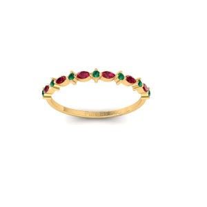 May include: A gold band ring with alternating marquise-cut red and green gemstones. The ring has a delicate design and the text "Pure Elegance" is engraved on the band.