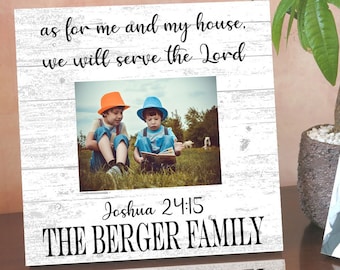 May include: White wooden picture frame with a whitewashed wood background. The frame has a photo of two boys wearing hats and reading a book. The text on the frame reads "as for me and my house, we will serve the Lord Joshua 24:15 THE BERGER FAMILY".
