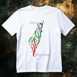 May include: White t-shirt with the words "FREE PALESTINE" in black and a stylized graphic in red, green, and black. The graphic resembles a map outline. The shirt is made of a soft, lightweight material.