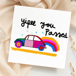 May include: A white greeting card with the words "yipee you Passed" in black script. A colorful cartoon car with a rainbow coming out of the back is on the card. The car is pink, blue, green, and red.
