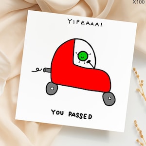 May include: A white greeting card with a cartoon illustration of a red car with a green character inside. The card reads "Yipeaaa!" at the top and "You Passed" at the bottom. The car has gray wheels and a black exhaust pipe.