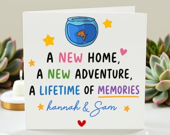 May include: A white greeting card with the text "A New Home, A New Adventure, A Lifetime of Memories" in various colors. The card features a cartoon fishbowl with a goldfish, stars, and hearts. The names "hannah & Sam" are also included.