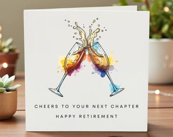 May include: White greeting card with an illustration of two champagne glasses clinking, with champagne splashing. The card reads "Cheers to your next chapter, Happy Retirement."