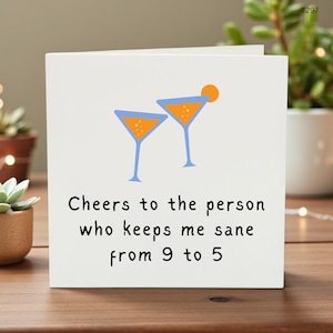 May include: White greeting card featuring two cartoon martini glasses in blue and orange. The card reads "Cheers to the person who keeps me sane from 9 to 5."