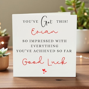 May include: A white greeting card with black and red text. The card reads "YOU'VE Got THIS! Evian SO IMPRESSED WITH EVERYTHING YOU'VE ACHIEVED SO FAR Good Luck" with two small red hearts at the bottom.