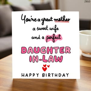 May include: A white birthday card with black and pink text. The card says "You're a great mother, a sweet wife, and a perfect daughter-in-law. Happy Birthday" with red hearts.