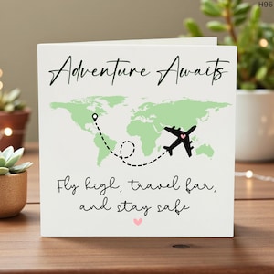 May include: A white card with the words "Adventure Awaits" in black script. A green world map is in the background, with a black airplane and dotted line. The text "Fly high, travel far, and stay safe" is below.