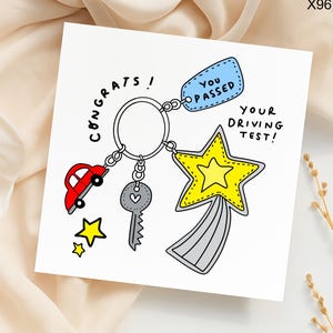 May include: A white card with a cartoon illustration of a keyring with a red car, a key, and a yellow star. The card says "Congrats!" and "You Passed Your Driving Test!"